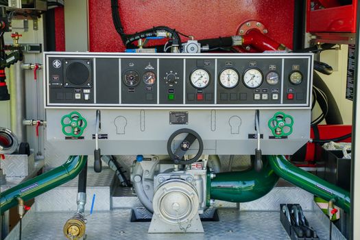 Close-up view of a fire truck dashboard with gauges and control levers.