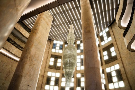 Elegant marble interior with a stunning crystal chandelier and architectural details.