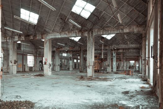 Discover the beauty of an abandoned warehouse interior with columns and derelict features.